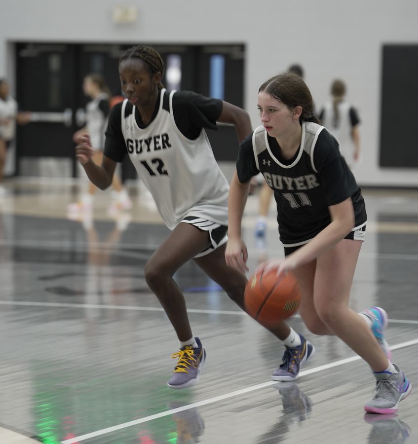 Emily drives with the ball as Keziah defends step for step.