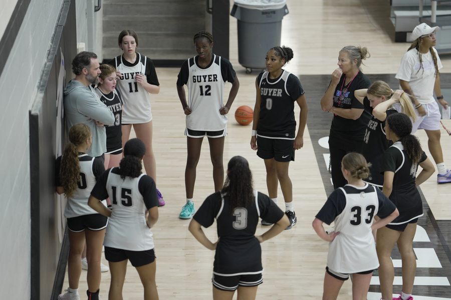 The Guyer team circles up with Coach Floyd and the staff in the gym in September.